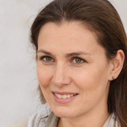 Joyful white adult female with medium  brown hair and brown eyes