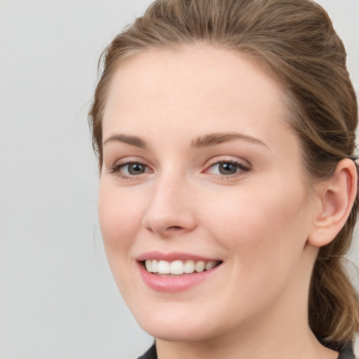 Joyful white young-adult female with long  brown hair and blue eyes