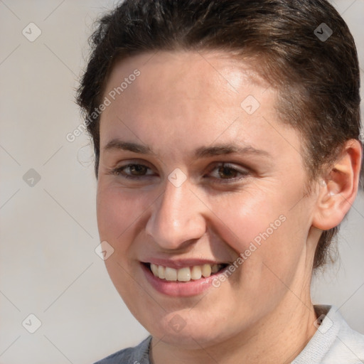 Joyful white young-adult female with short  brown hair and brown eyes