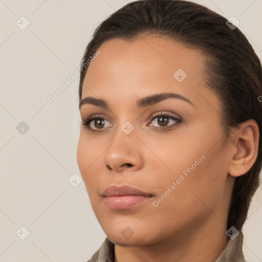 Joyful latino young-adult female with long  brown hair and brown eyes