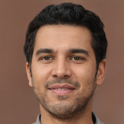 Joyful latino young-adult male with short  black hair and brown eyes