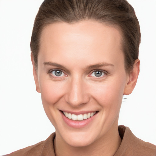 Joyful white young-adult female with short  brown hair and grey eyes