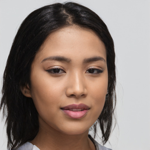 Joyful latino young-adult female with medium  black hair and brown eyes