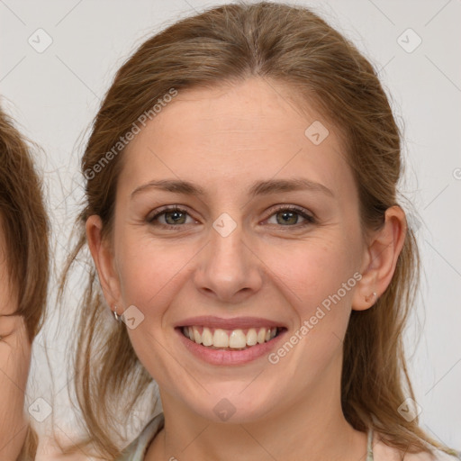 Joyful white young-adult female with medium  brown hair and grey eyes