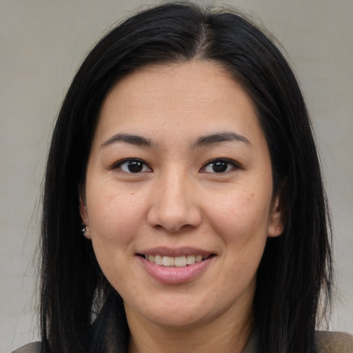 Joyful asian young-adult female with long  brown hair and brown eyes