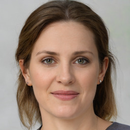 Joyful white young-adult female with medium  brown hair and green eyes