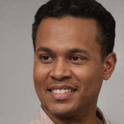 Joyful latino young-adult male with short  brown hair and brown eyes