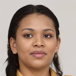 Joyful black young-adult female with long  brown hair and brown eyes
