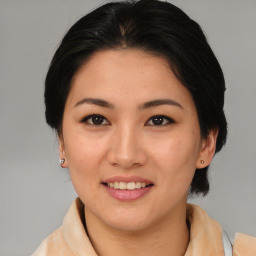 Joyful asian young-adult female with medium  brown hair and brown eyes