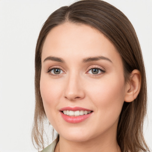 Joyful white young-adult female with long  brown hair and grey eyes