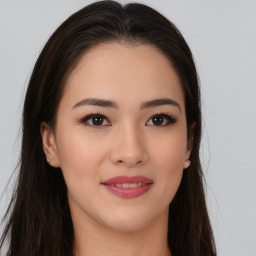 Joyful asian young-adult female with long  brown hair and brown eyes