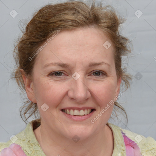 Joyful white adult female with medium  brown hair and blue eyes