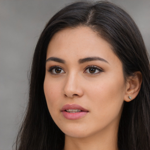 Joyful latino young-adult female with long  brown hair and brown eyes