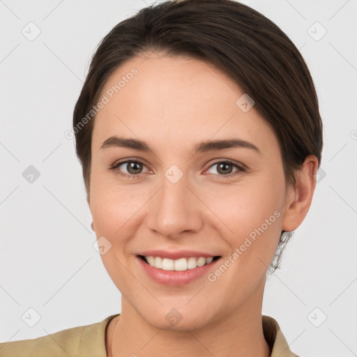 Joyful white young-adult female with short  brown hair and brown eyes