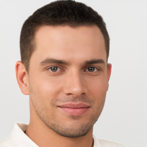 Joyful white young-adult male with short  brown hair and brown eyes