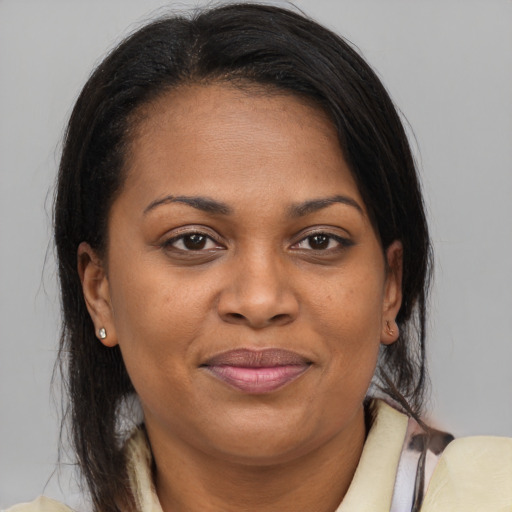 Joyful black adult female with medium  brown hair and brown eyes