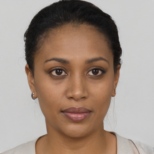 Joyful black young-adult female with short  black hair and brown eyes