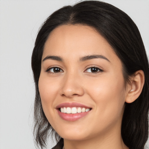 Joyful white young-adult female with long  black hair and brown eyes