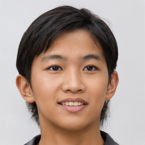 Joyful asian young-adult male with medium  brown hair and brown eyes