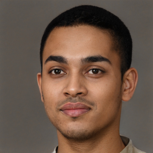 Joyful black young-adult male with short  black hair and brown eyes