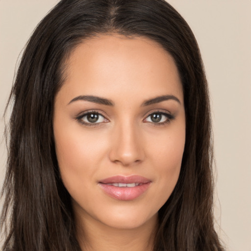 Joyful white young-adult female with long  brown hair and brown eyes