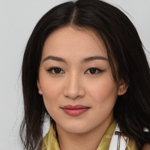 Joyful asian young-adult female with long  brown hair and brown eyes