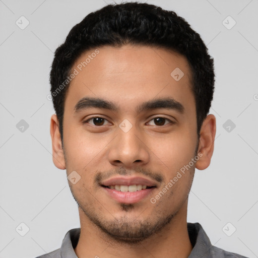 Joyful latino young-adult male with short  black hair and brown eyes