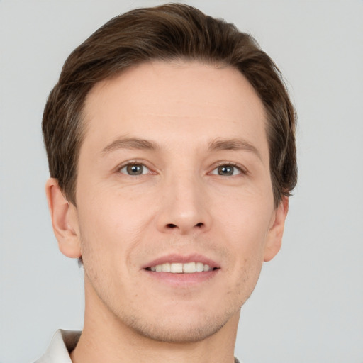 Joyful white adult male with short  brown hair and grey eyes