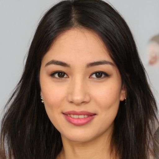 Joyful asian young-adult female with long  brown hair and brown eyes