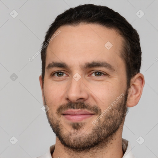 Joyful white young-adult male with short  black hair and brown eyes