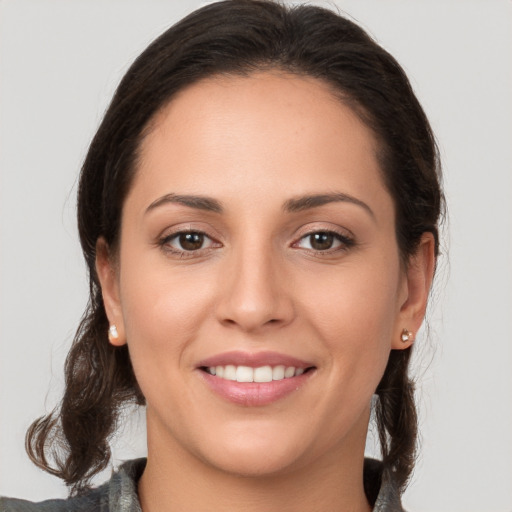 Joyful white young-adult female with medium  brown hair and brown eyes