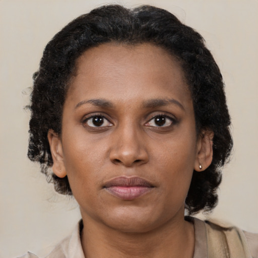 Neutral black young-adult female with long  brown hair and brown eyes
