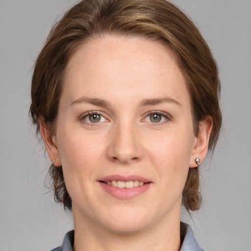 Joyful white young-adult female with medium  brown hair and blue eyes