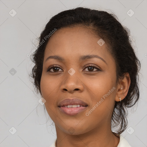 Joyful black young-adult female with long  brown hair and brown eyes