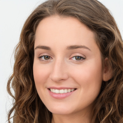 Joyful white young-adult female with long  brown hair and green eyes