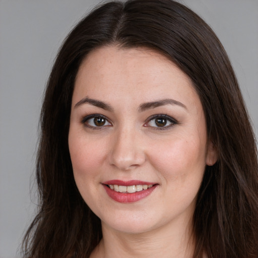 Joyful white young-adult female with long  brown hair and brown eyes