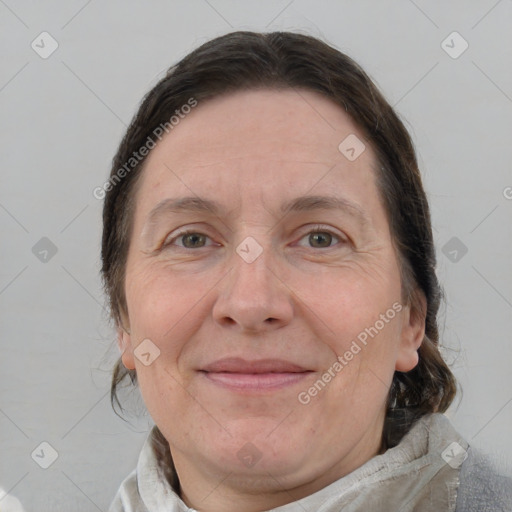 Joyful white adult female with medium  brown hair and blue eyes