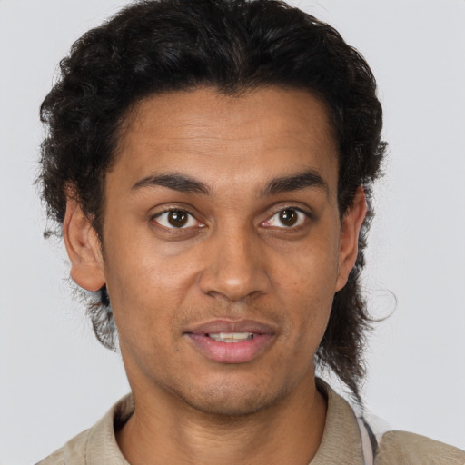 Joyful latino young-adult male with short  brown hair and brown eyes