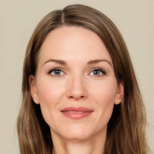 Joyful white young-adult female with long  brown hair and grey eyes