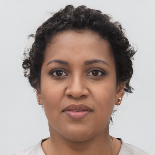 Joyful black young-adult female with short  brown hair and brown eyes