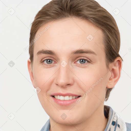 Joyful white young-adult female with short  brown hair and grey eyes