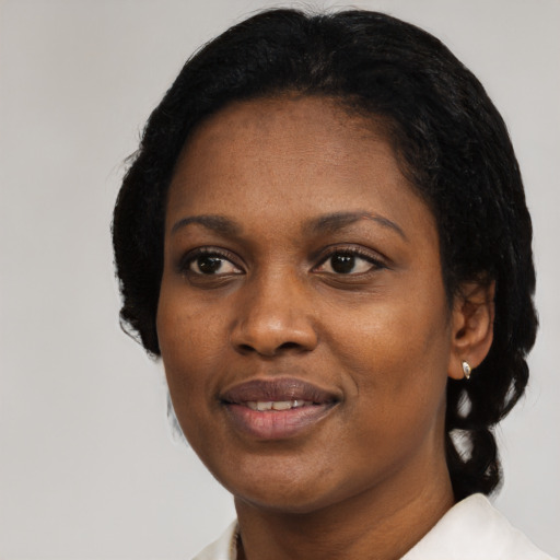Joyful black adult female with medium  black hair and brown eyes