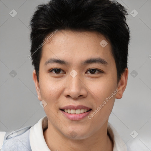 Joyful asian young-adult male with short  brown hair and brown eyes