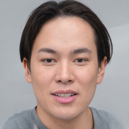 Joyful asian young-adult male with short  brown hair and brown eyes