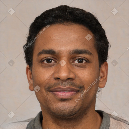 Joyful black young-adult male with short  black hair and brown eyes