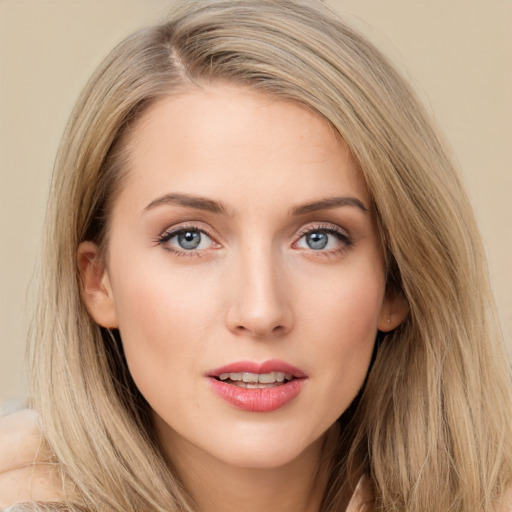 Joyful white young-adult female with long  brown hair and blue eyes