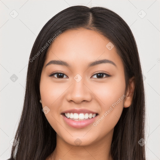 Joyful latino young-adult female with long  black hair and brown eyes