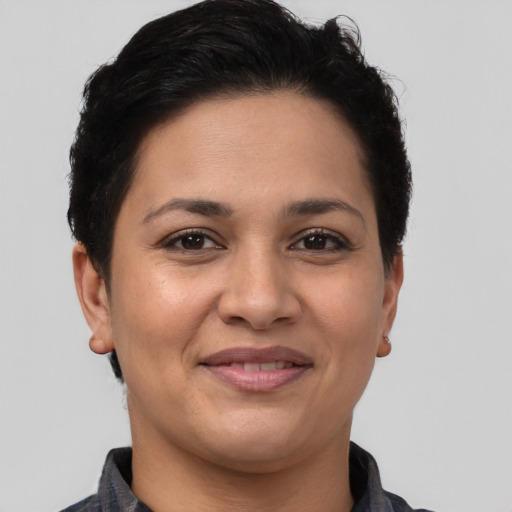 Joyful latino adult female with short  brown hair and brown eyes