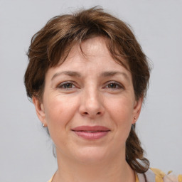 Joyful white adult female with medium  brown hair and brown eyes