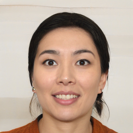 Joyful white young-adult female with medium  black hair and brown eyes